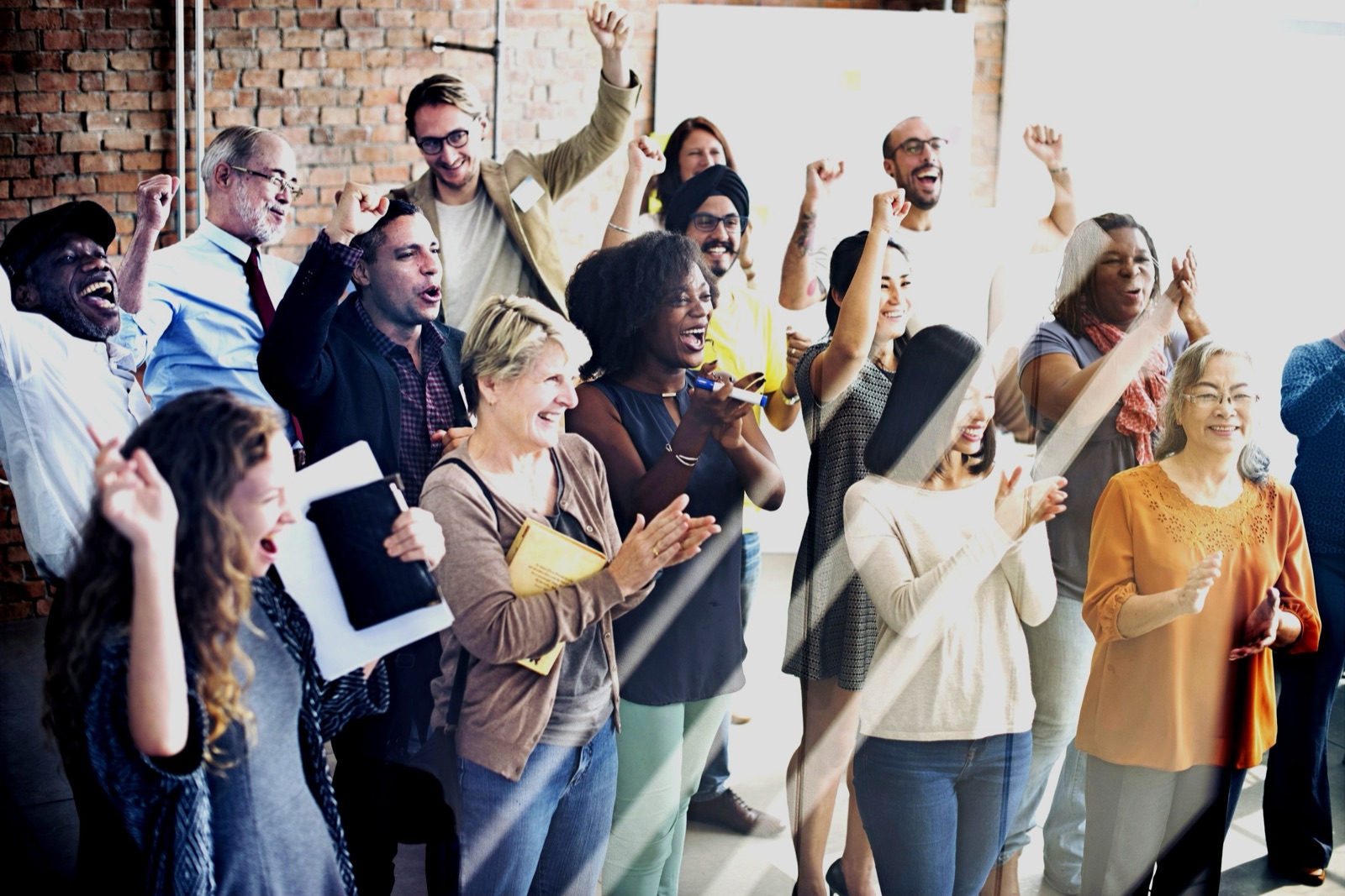 A laughter yoga group clapping and laughing together