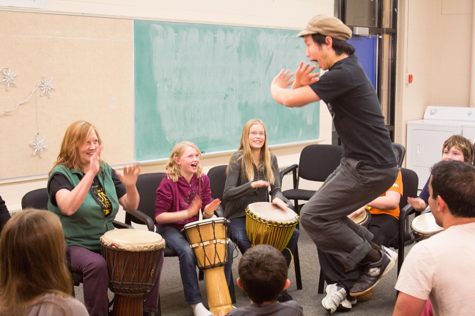 Marcus leading a creative movement activity with a seated group